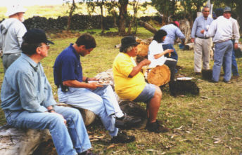 The team and local officials partake of the umu tahu
