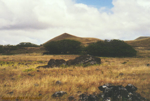 A giant Moai lies supine and broken a mile from the quarry