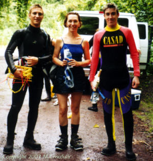 Volunteers Brad, Karen, and Morgan, suited up and ready for work.